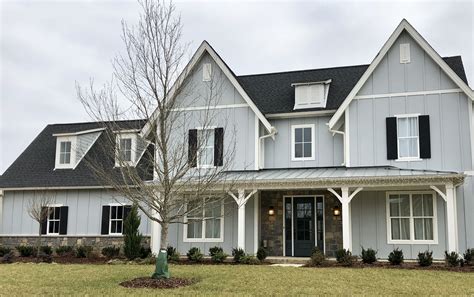 gray house with metal roof|black roof with gray siding.